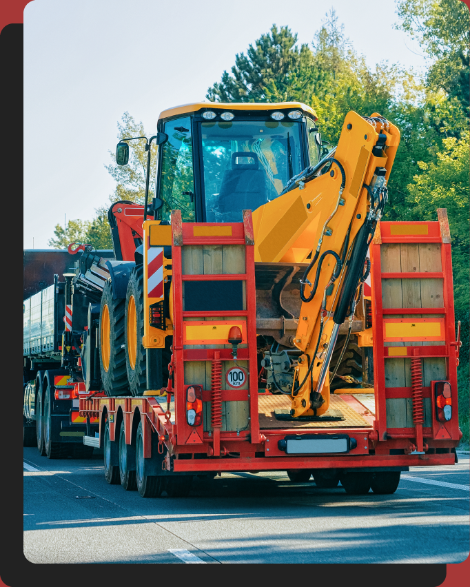 Construction equipment being transported on a trailer